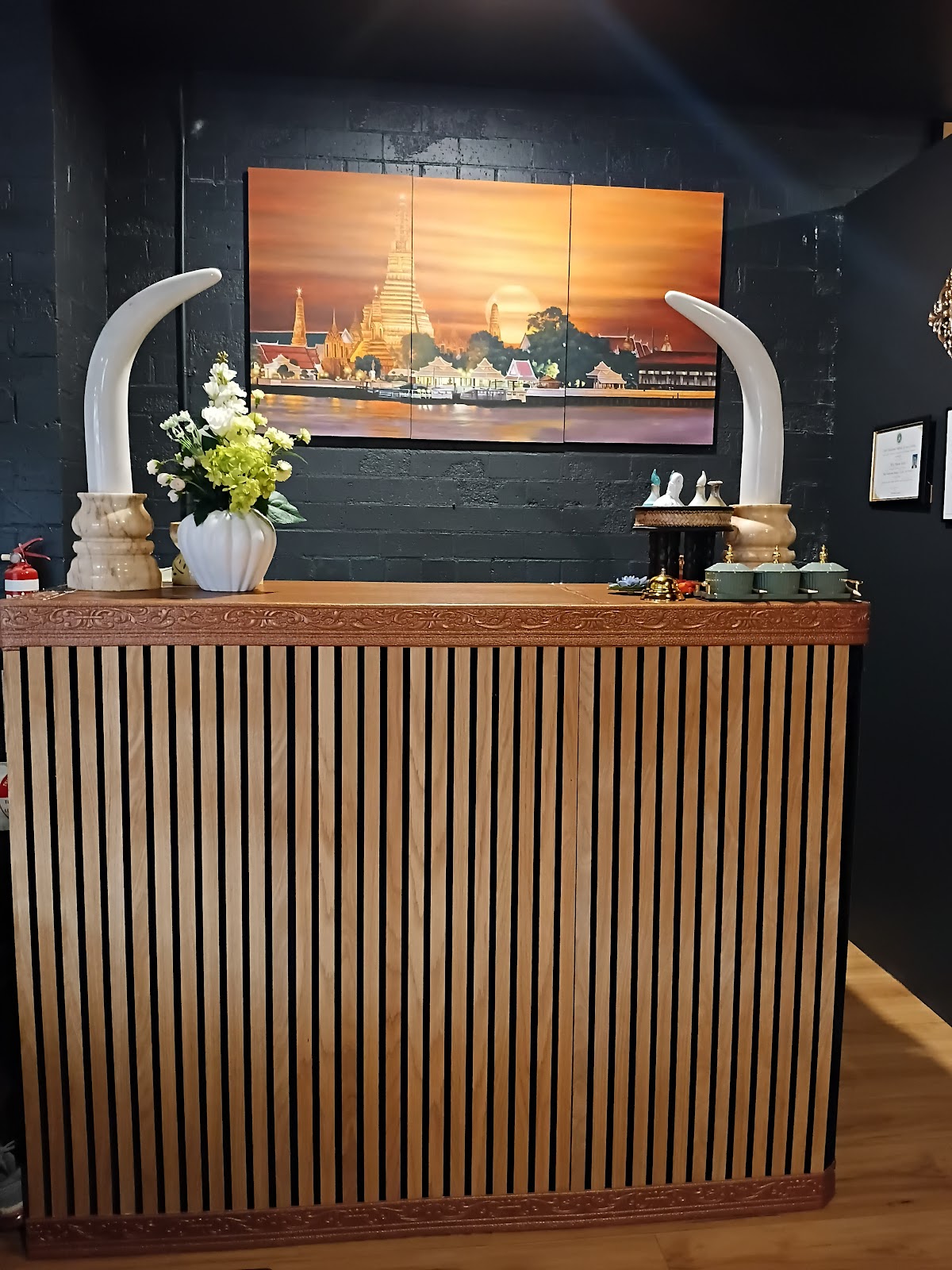 The front counter with fresh flowers and the temple painting